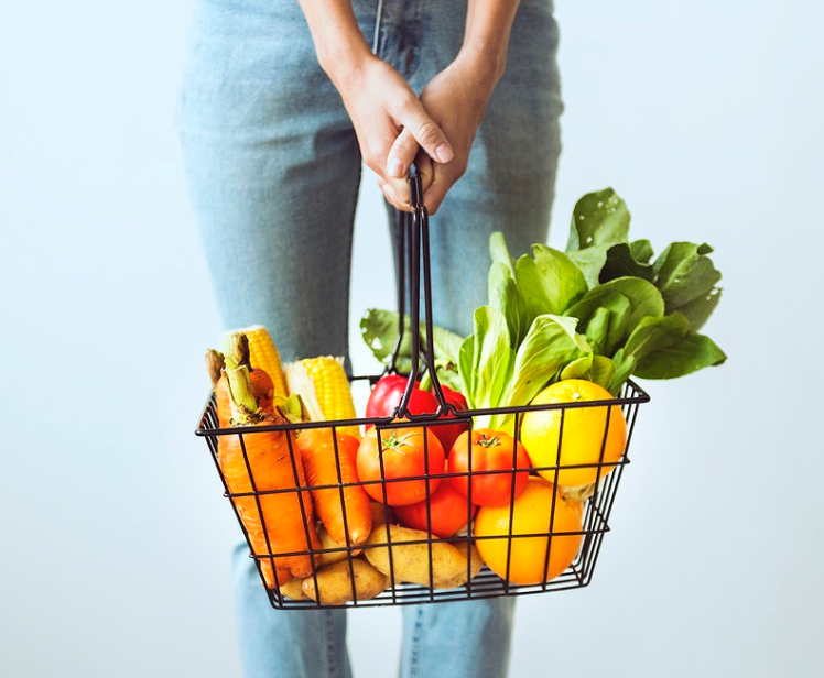 holding cart full of vegetables